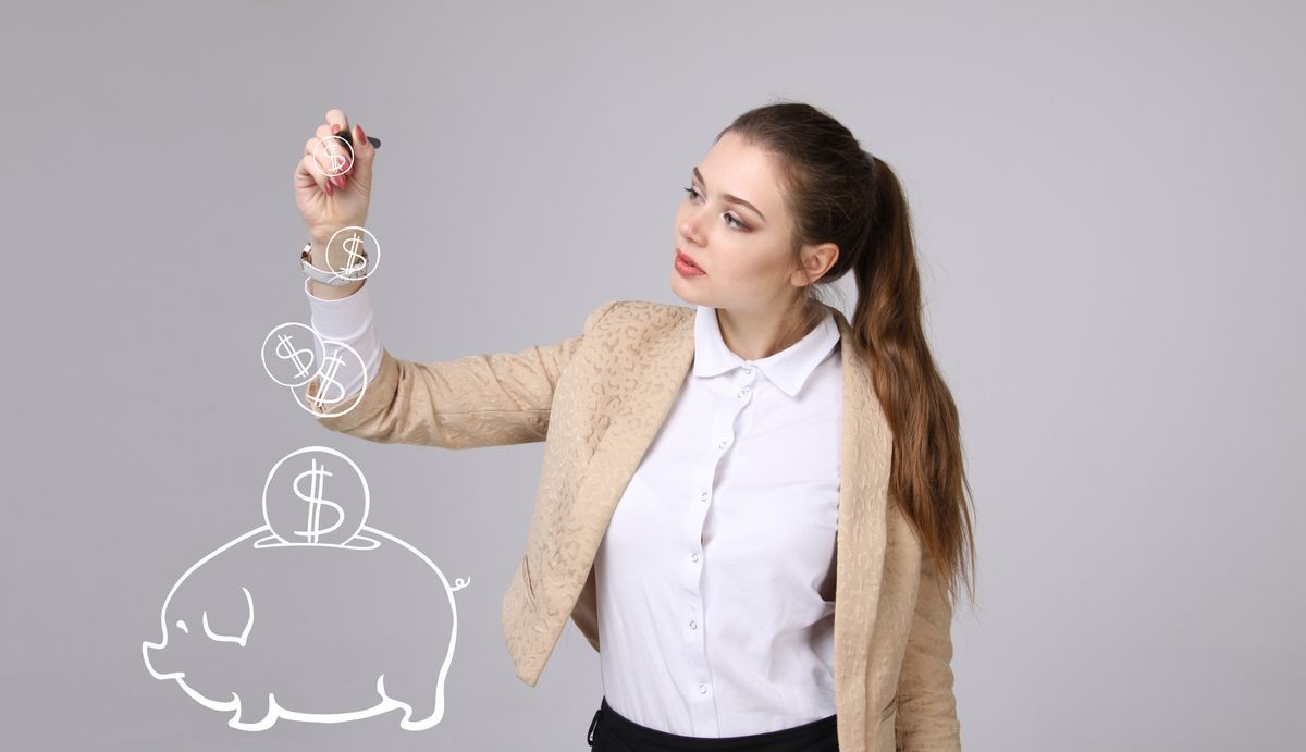 young woman drawing a piggy Bank