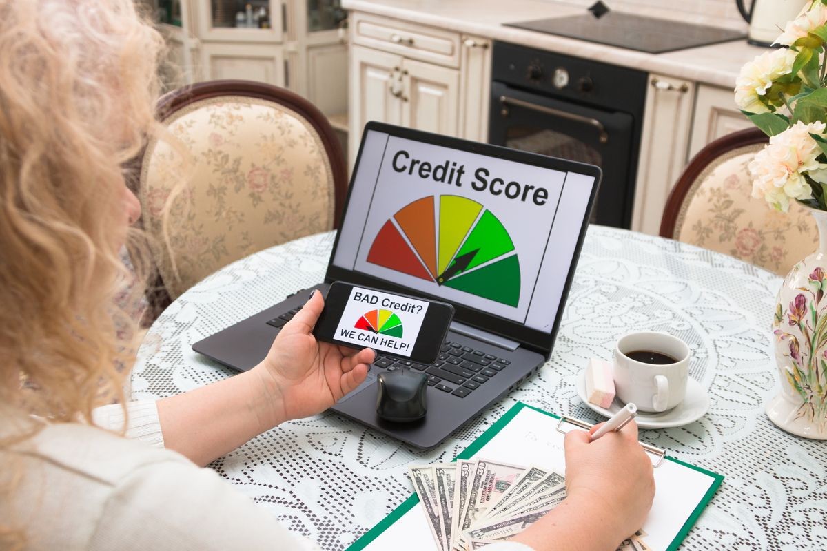 Woman in the age of housewife calculates his finances and analyzes the credit history, compiles a credit report on a computer. Credit score. Laptop. Technology.